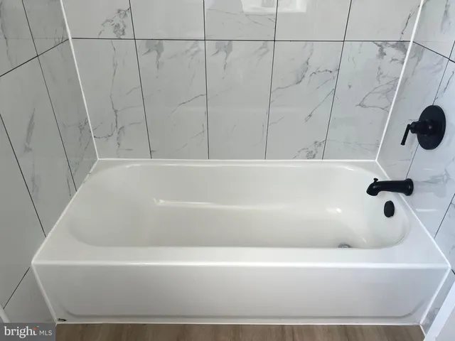 a kitchen with a sink cabinets and wooden floor