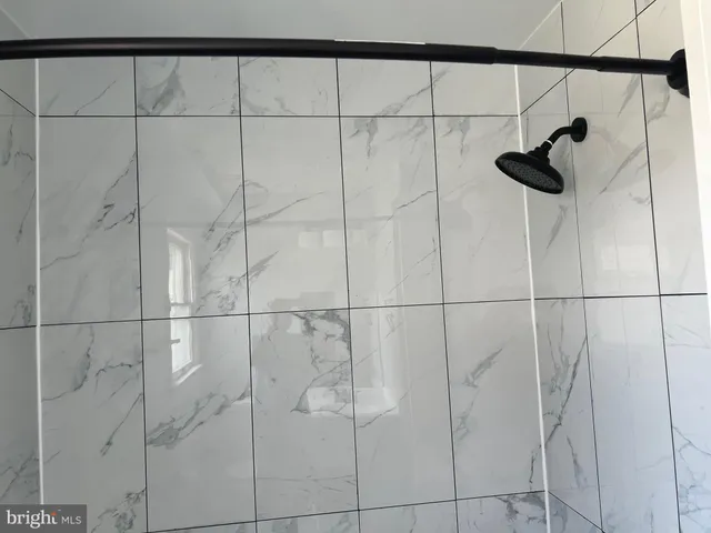 a bathroom with a sink a mirror and a shower