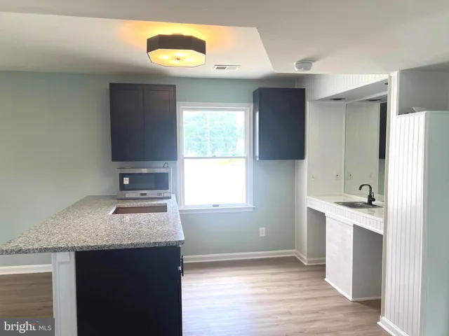 a view of staircase with wooden floor and entryway