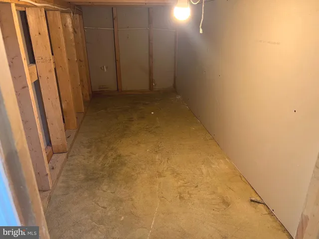 a view of empty room with wooden floor and window