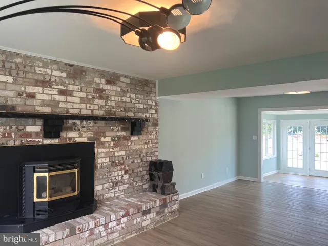 a view of a room with wooden floor and staircase