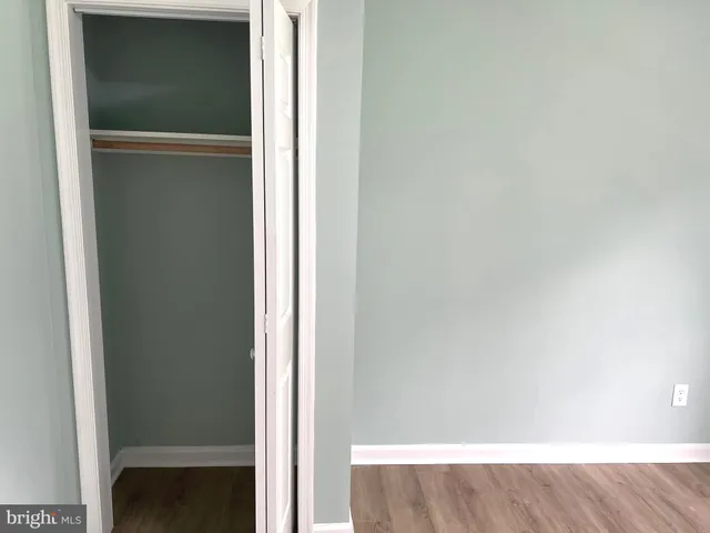 a view of a room with wooden floor and a window