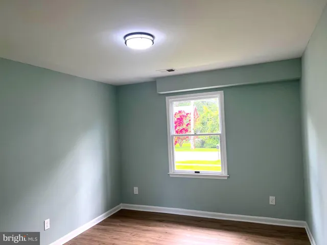 a white toilet sitting next to a window in a bathroom