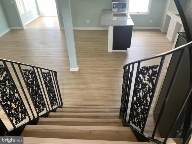a view of staircase with white walls and railing