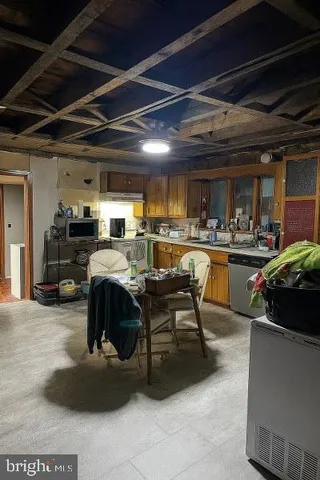 a living room with lots of furniture and kitchen