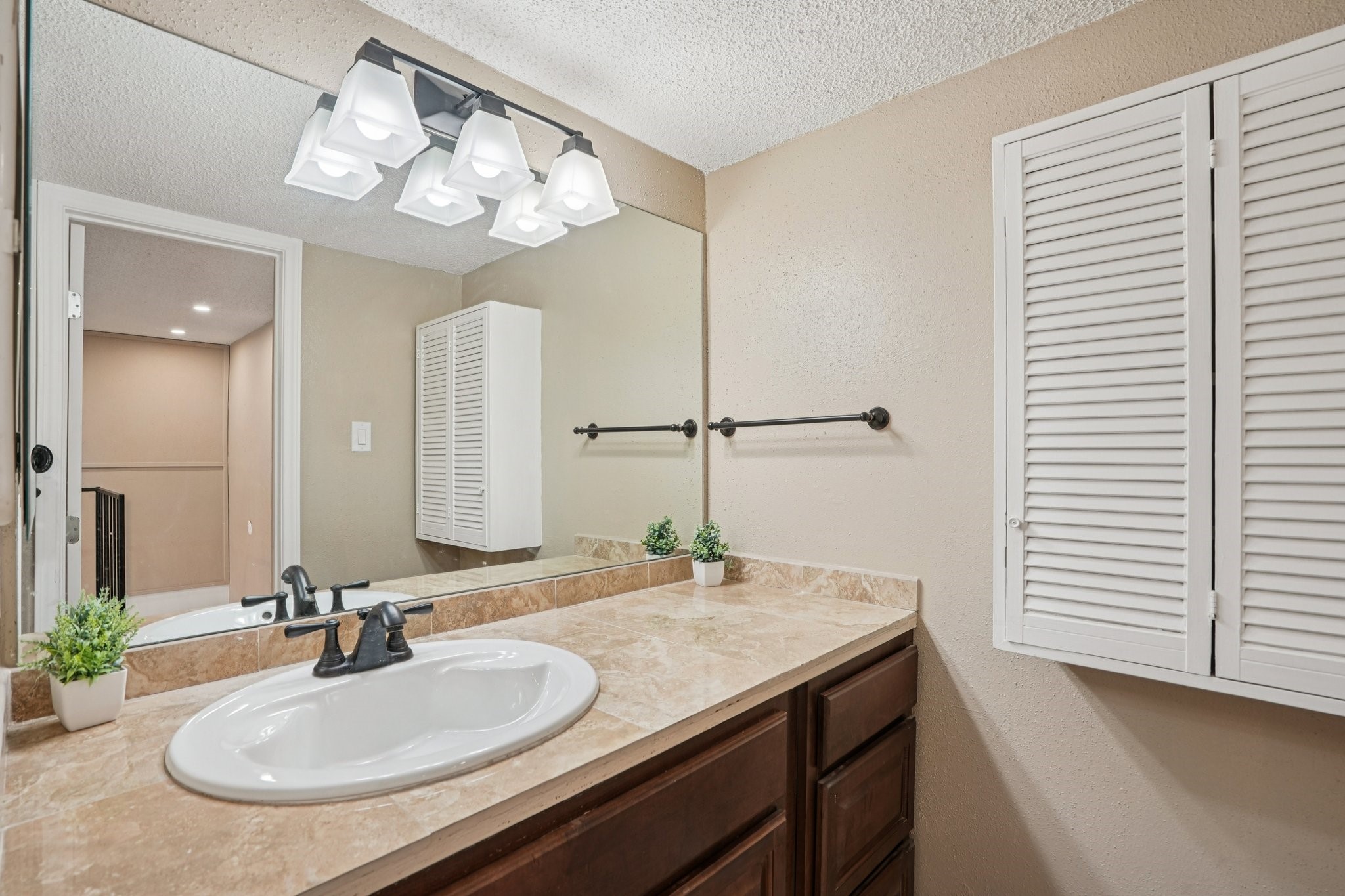 2800 Jeanetta Street, Unit 203 Houston, TX 77063 - Photo 20 of 28 a bathroom with a sink and a mirror