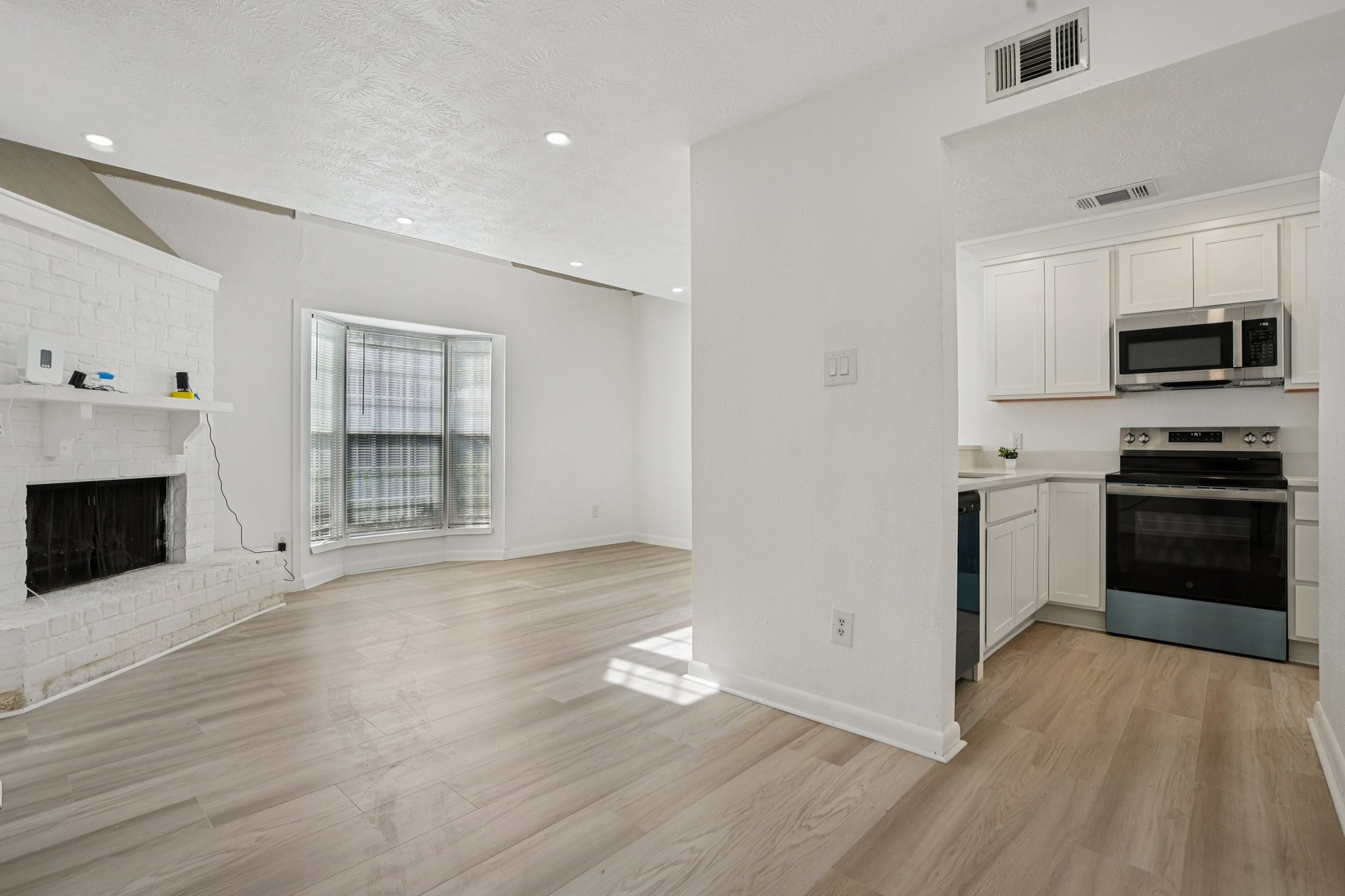 2800 Jeanetta Street, Unit 203 Houston, TX 77063 - Photo 7 of 28 a kitchen with granite countertop a stove a sink and a refrigerator