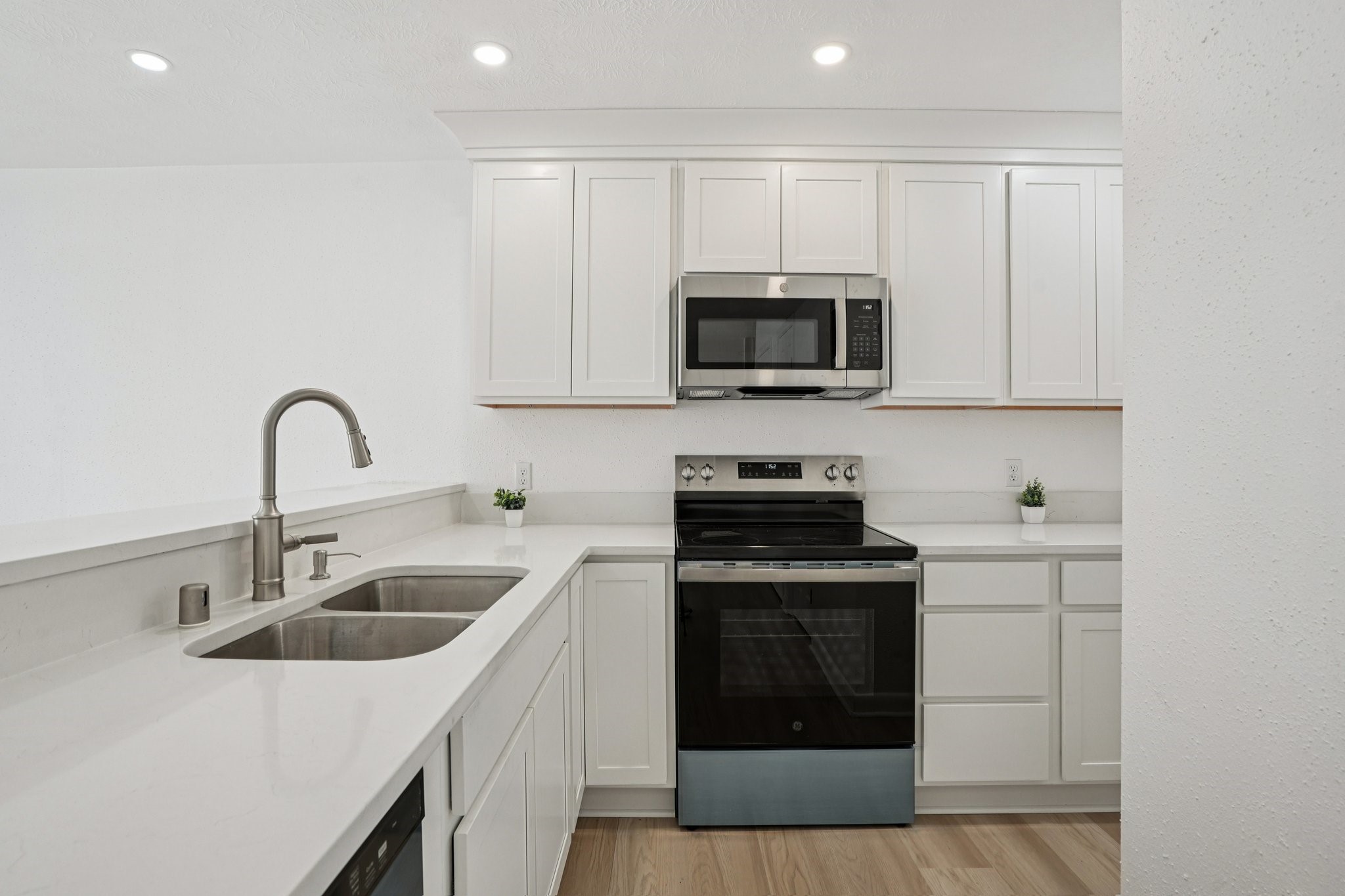 2800 Jeanetta Street, Unit 203 Houston, TX 77063 - Photo 10 of 28 a kitchen with white cabinets a sink and stainless steel appliances