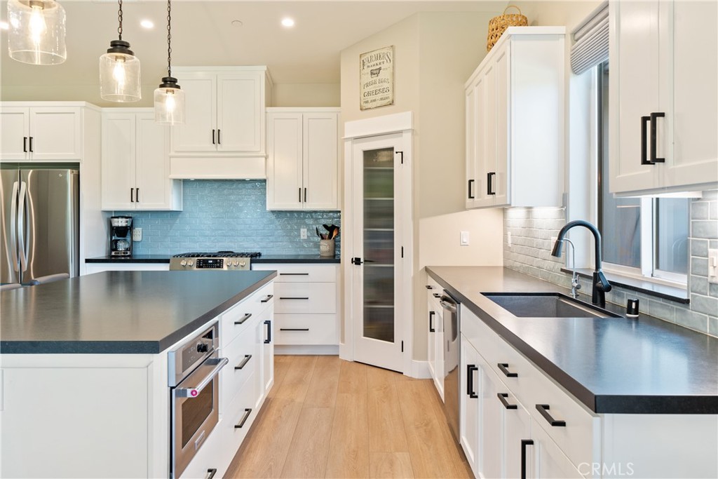 8550 El Corte Road Atascadero, CA 93422 - Photo 18 of 72 a kitchen with stainless steel appliances granite countertop a sink a stove and a refrigerator
