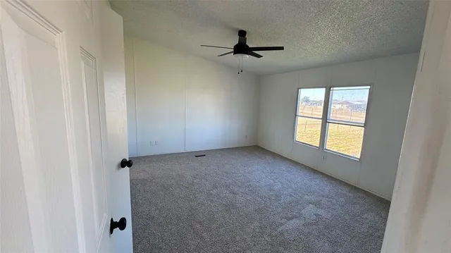 a view of room with window and ceiling fan