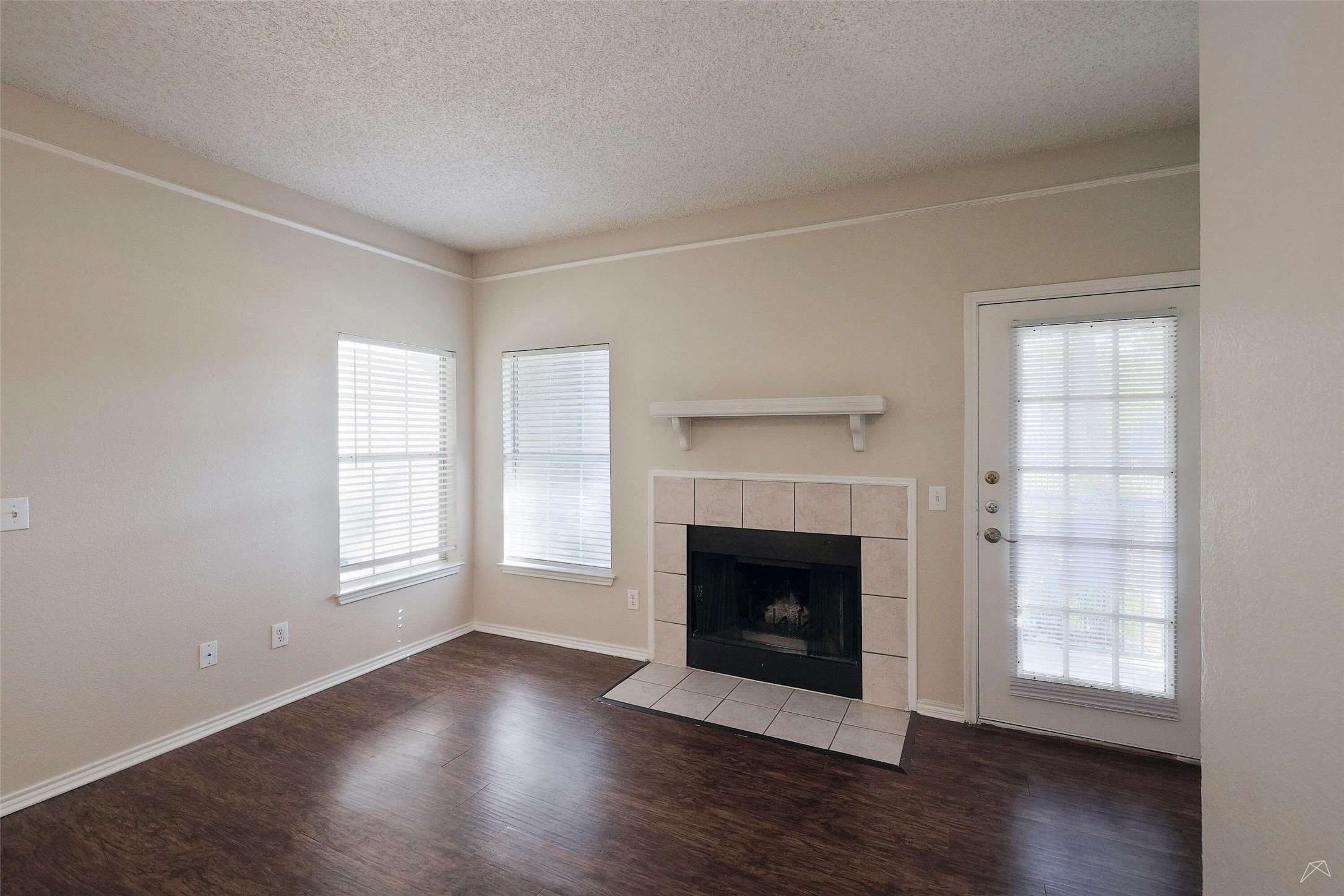 11908 Anderson Mill Road, Unit 331 Cedar Park, TX 78613 - Photo 11 of 24 an empty room with wooden floor fireplace and windows