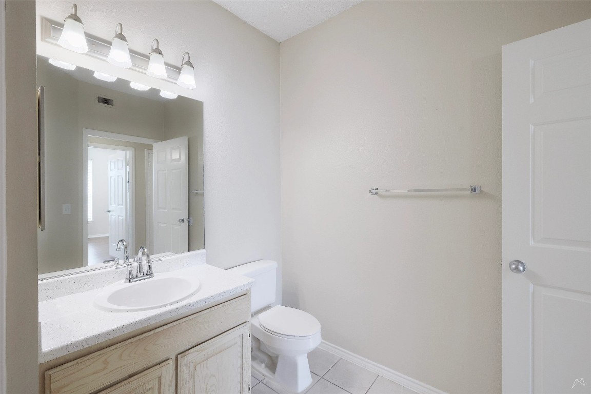11908 Anderson Mill Road, Unit 331 Austin, TX 78726 - Photo 14 of 24 a bathroom with a toilet sink and mirror