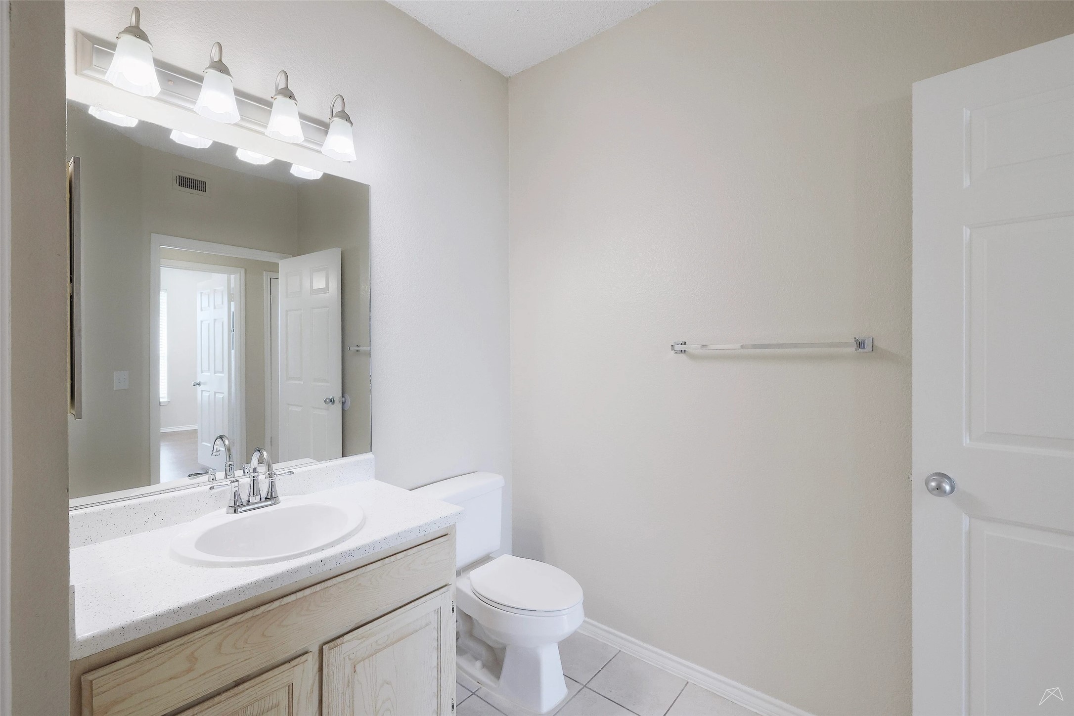 11908 Anderson Mill Road, Unit 331 Cedar Park, TX 78613 - Photo 14 of 24 a bathroom with a toilet sink and mirror