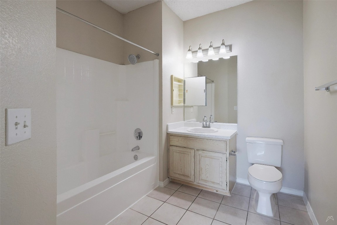 11908 Anderson Mill Road, Unit 331 Austin, TX 78726 - Photo 15 of 24 a bathroom with a sink vanity mirror and toilet