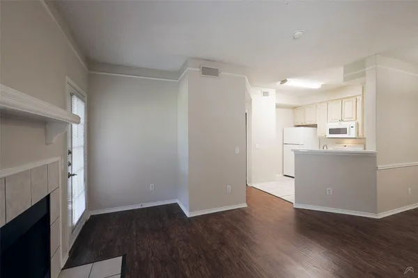 a view of a kitchen with wooden floor and a kitchen