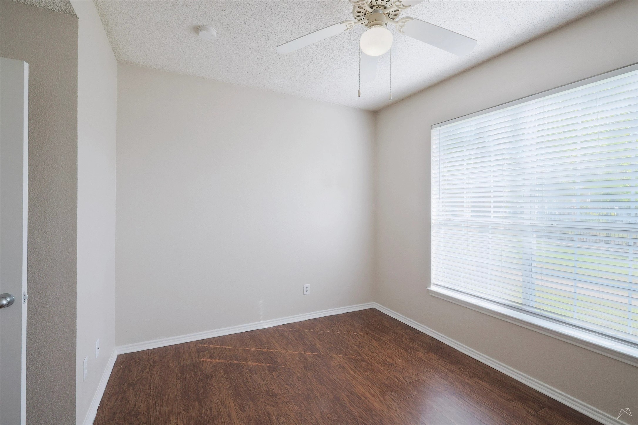 11908 Anderson Mill Road, Unit 331 Cedar Park, TX 78613 - Photo 7 of 24 wooden floor in an empty room with a window