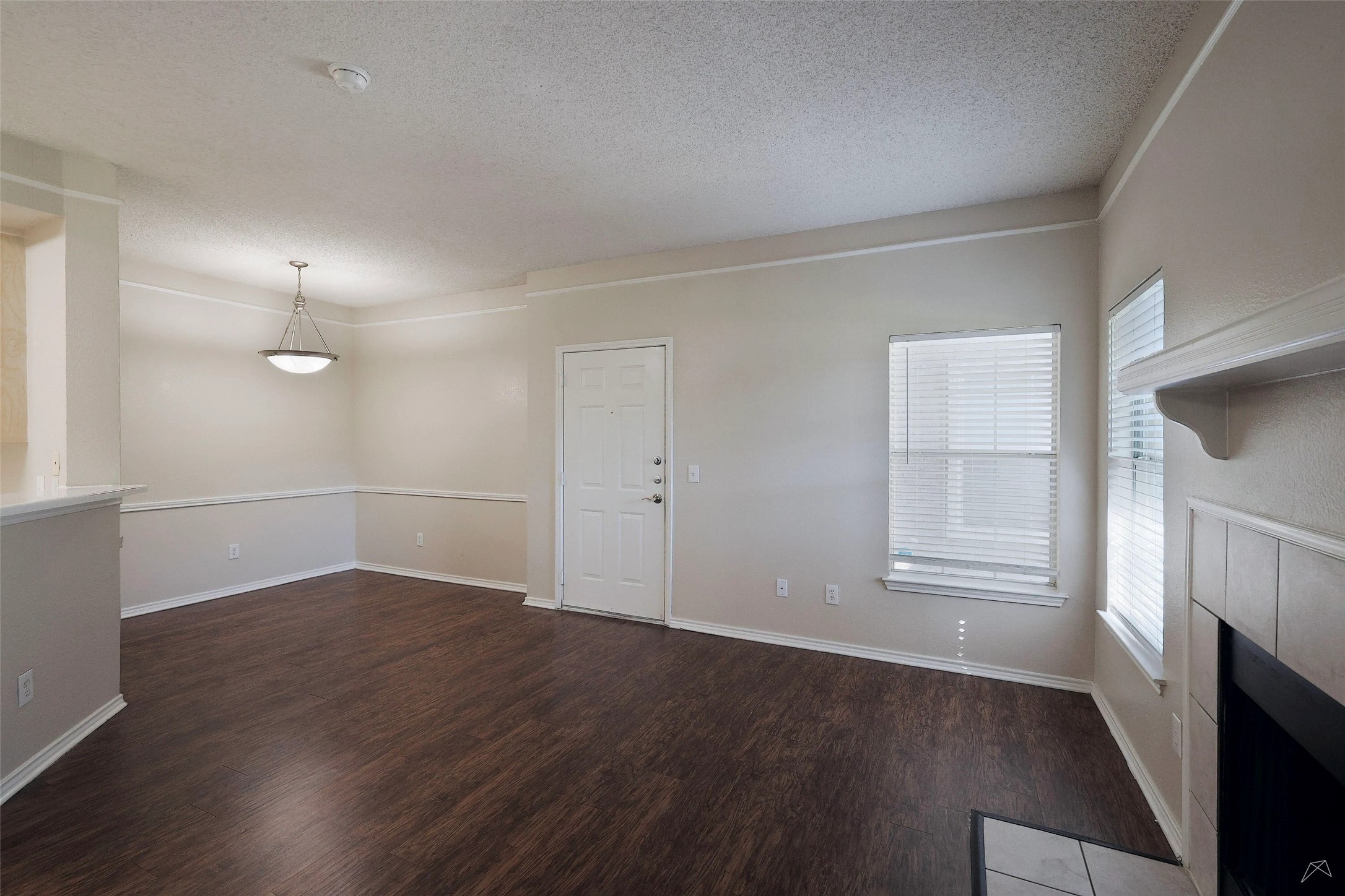 11908 Anderson Mill Road, Unit 331 Cedar Park, TX 78613 - Photo 9 of 24 an empty room with wooden floor and windows