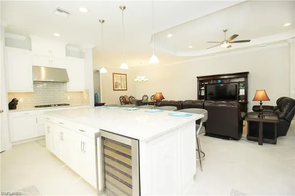 a kitchen with a stove a sink and a refrigerator