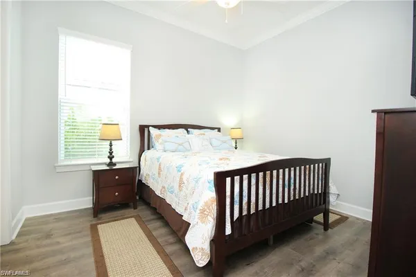 a bed sitting in a bedroom next to a window