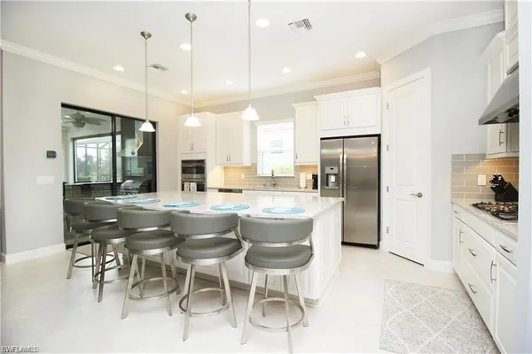 a large kitchen with a table and chairs