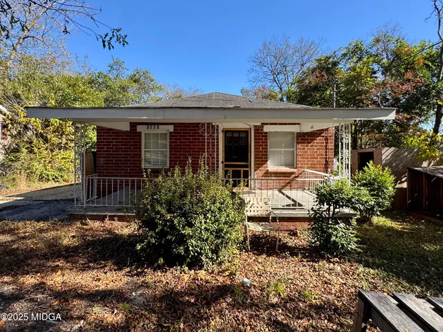 a front view of house with a garden