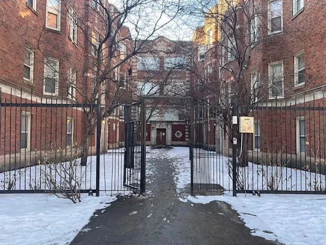 a view of a house with a wooden fence