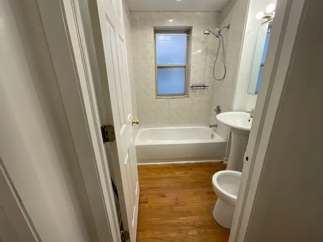 a bathroom with a bathtub a sink and a shower