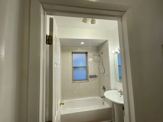 a bathroom with a bathtub and a shower
