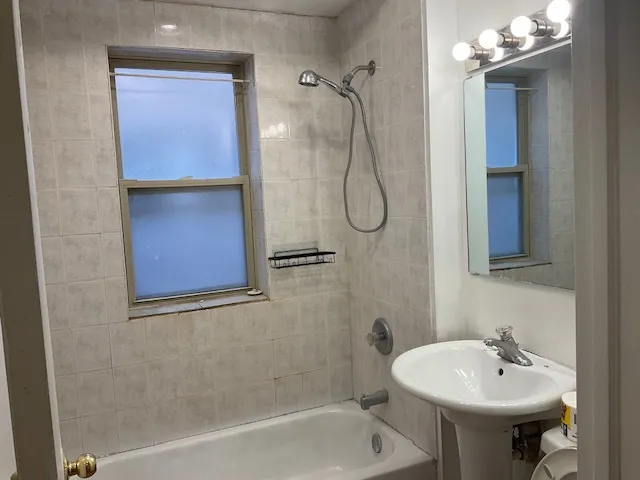a bathroom with a sink a mirror and a shower