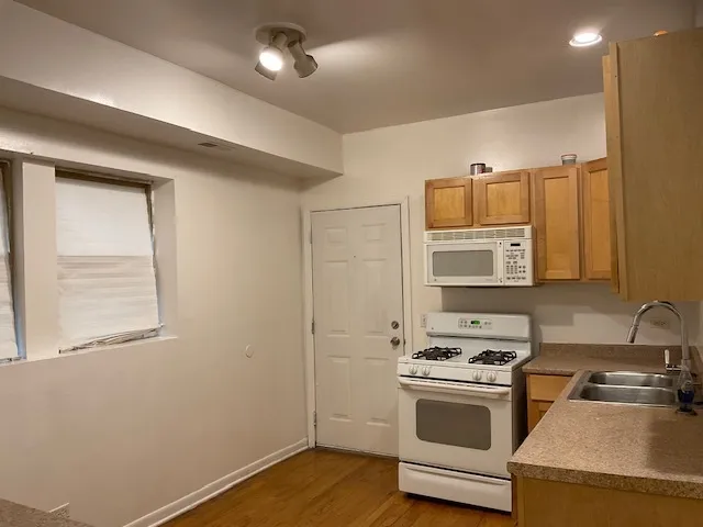 a kitchen with a sink stove and microwave