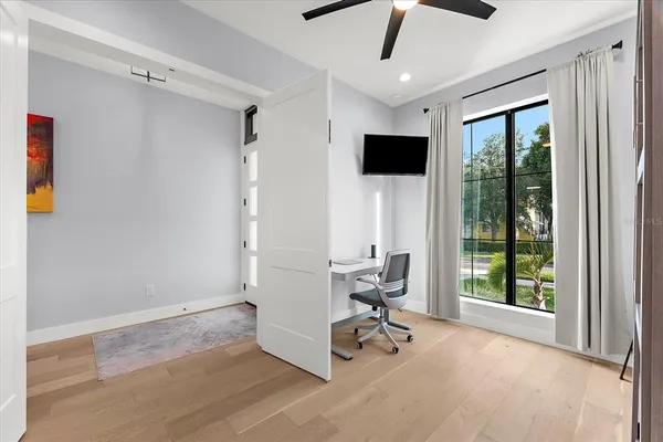 a spacious bathroom with a double vanity sink a large mirror and a bathtub