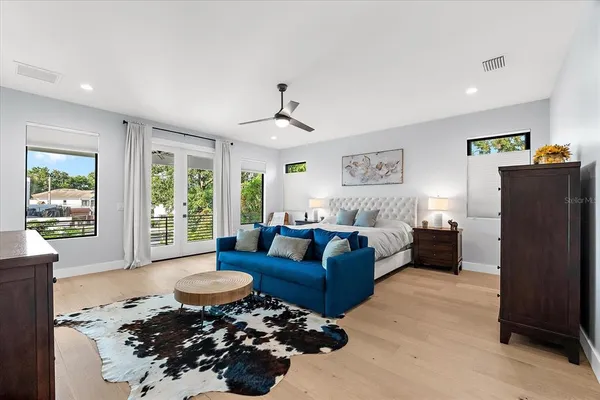 a living room with furniture a flat screen tv and a large window
