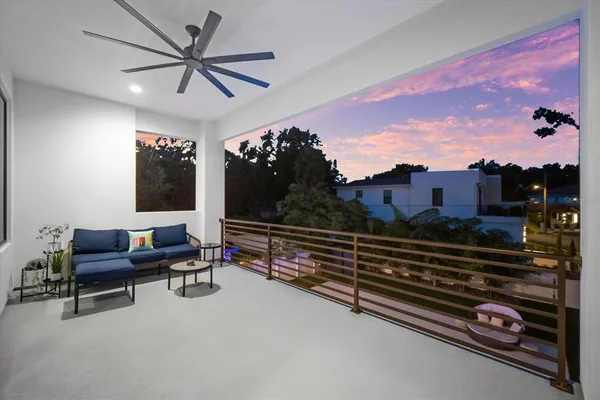 a living room with furniture a flat screen tv and a large window