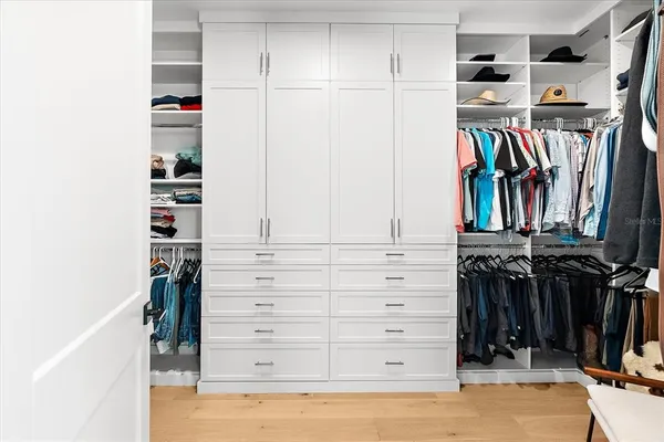 a view of backyard with swimming pool and seating space