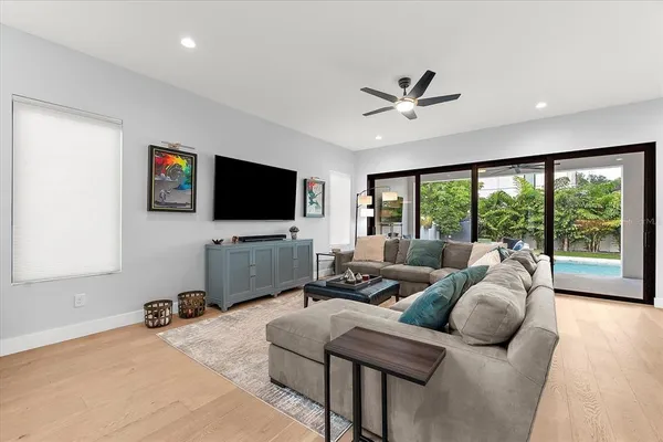 a kitchen with stainless steel appliances kitchen island granite countertop a table chairs sink and cabinets