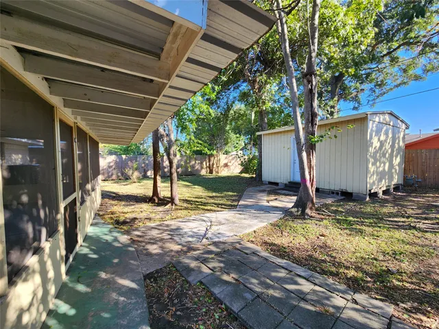a view of a backyard with a tree