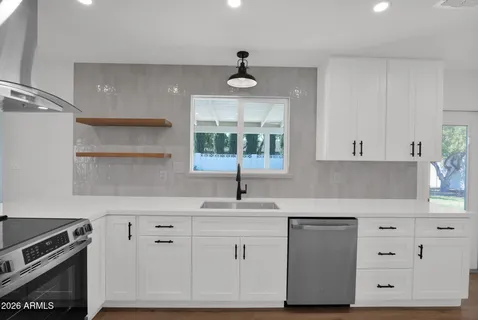 a kitchen with white cabinets and white appliances
