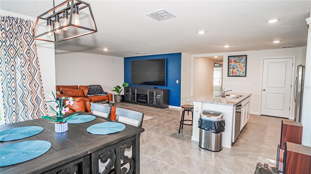 13253 Mylion Way Spring Hill, FL 34610 - Photo 11 of 31 a living room with furniture and a flat screen tv