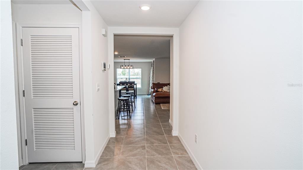 13253 Mylion Way Spring Hill, FL 34610 - Photo 19 of 31 a view of a hallway with dining room and wooden floor