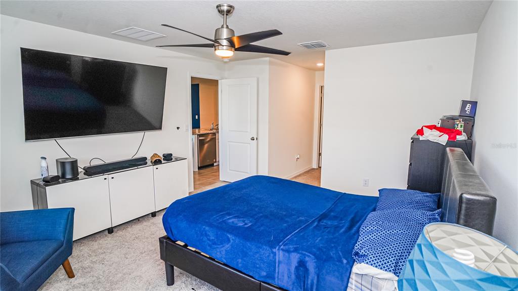 13253 Mylion Way Spring Hill, FL 34610 - Photo 21 of 31 a bedroom with a bed and a flat screen tv