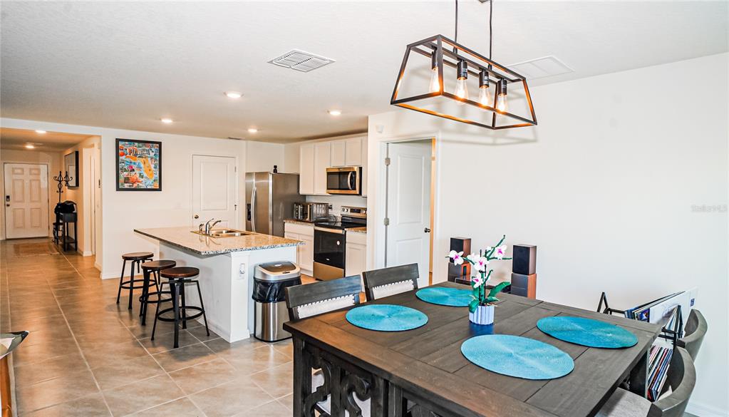 13253 Mylion Way Spring Hill, FL 34610 - Photo 10 of 31 a view of a dining room with furniture and wooden floor