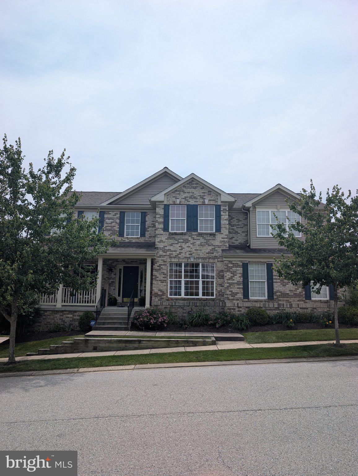 5017 Autumn Glow Way Perry Hall, MD 21128 - Photo 1 of 1 Charming brick facade with lush greenery.
