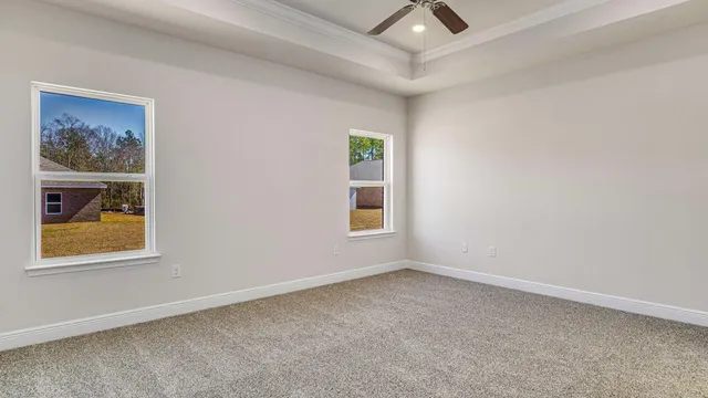 an empty room with windows and closet