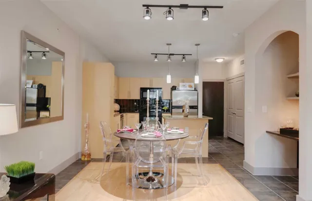 a dining room with furniture a window and kitchen view