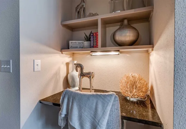 a living room with furniture and a mirror