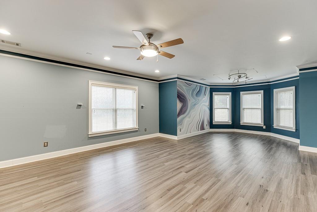940 Chateau Forest Road Hoschton, GA 30548 - Photo 67 of 87 a view of an empty room with a window and wooden floor