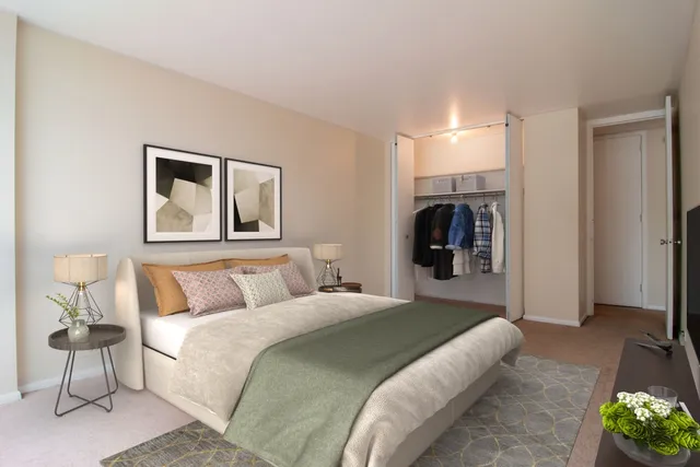 a bedroom with a bed and a painting