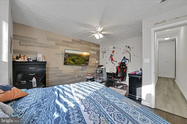 a bedroom with bed and a chandelier