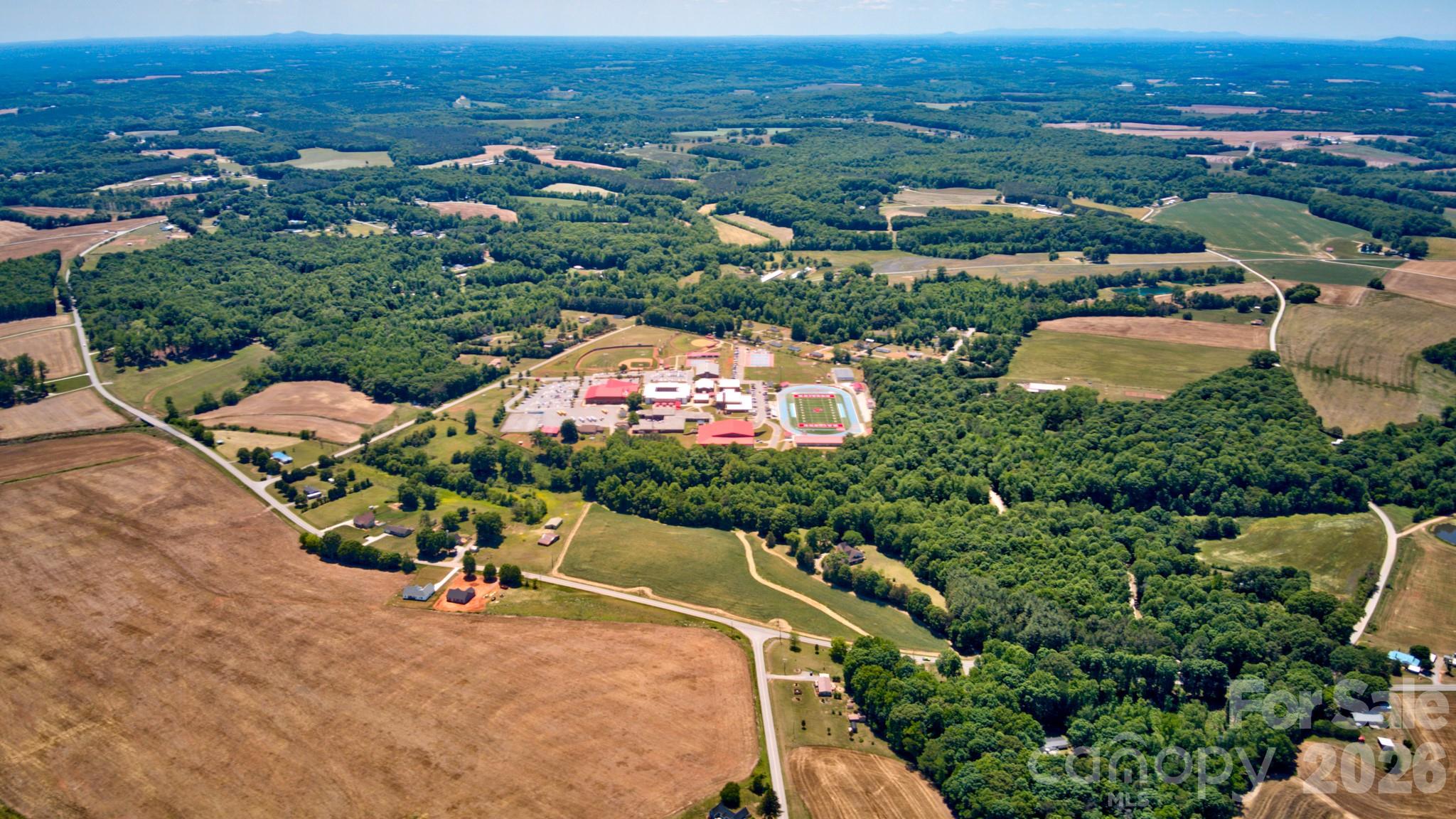 0 Jennings Road Olin, NC 28660 - Photo 26 of 33 an aerial view of a city with lots of residential buildings ocean and mountain view in back