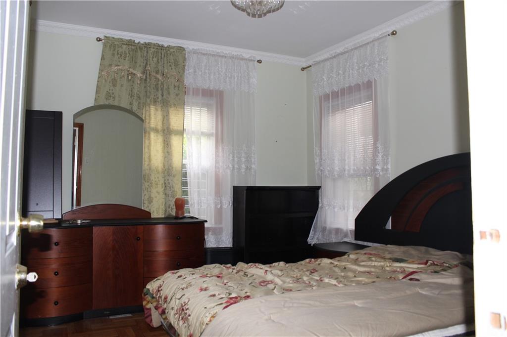6 Brighton 10th Terrace Brooklyn, NY 11235 - Photo 4 of 8 a bedroom with a bed and a window